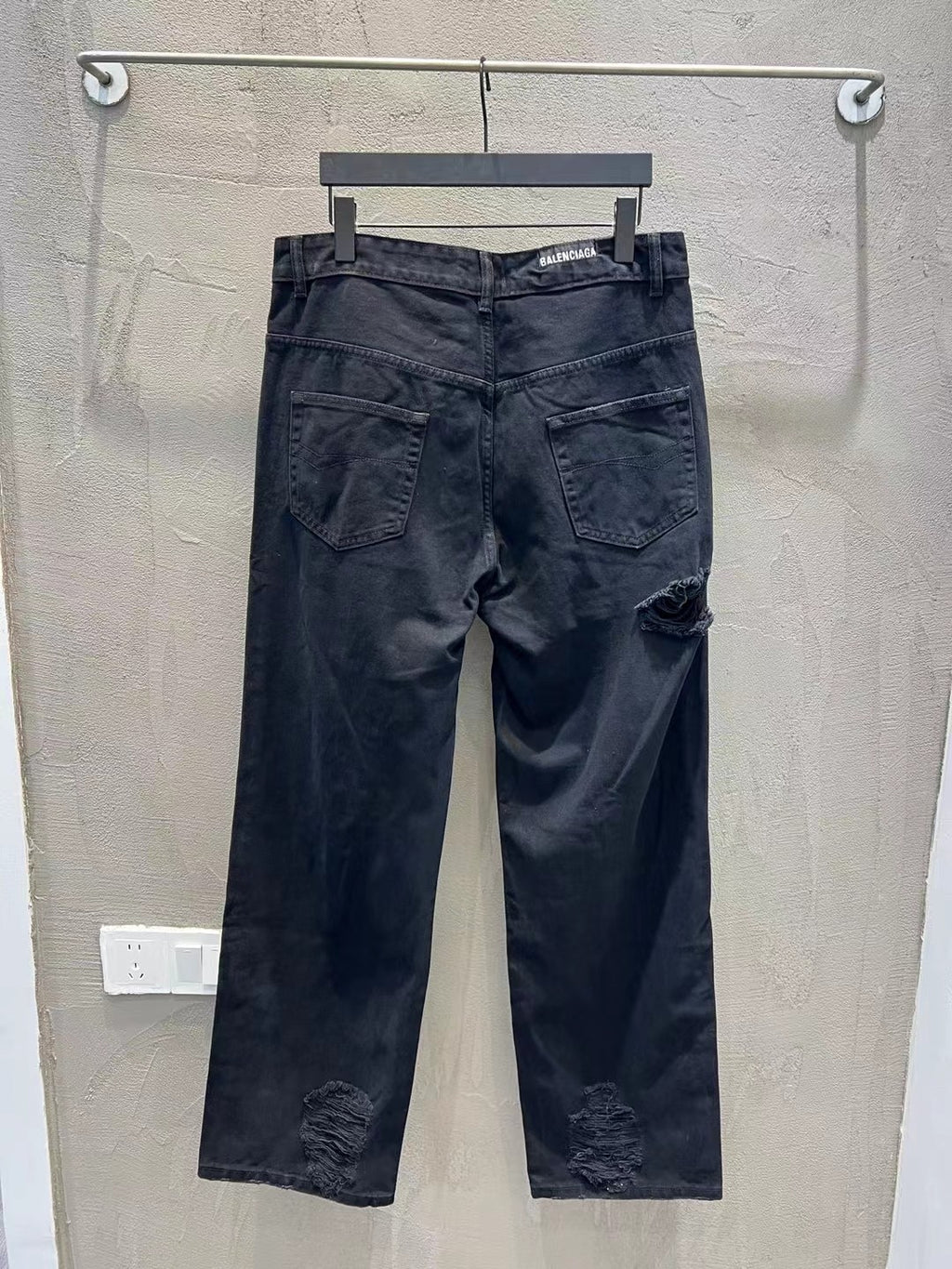 Balenciaga dark denim jeans with distressed patches and mid-rise waistband