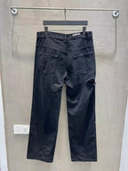 Balenciaga dark denim jeans with distressed patches and mid-rise waistband