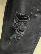 Balenciaga dark denim jeans close-up of layered ripped fabric on the leg