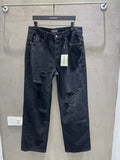 Balenciaga dark denim jeans with ripped knees and front button closure