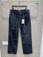 Balenciaga dark denim jeans with ripped knees and front button closure