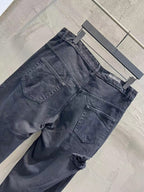 Balenciaga dark denim jeans angled view with front pockets and distressing