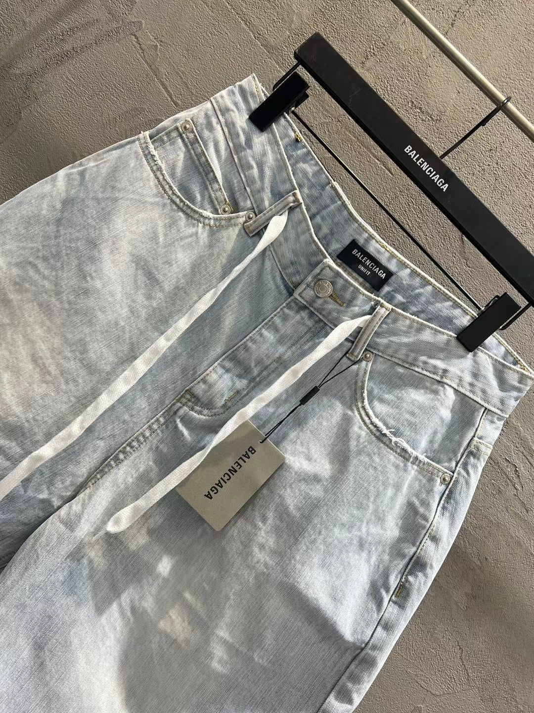 Light-wash denim shorts with front pockets, belt loops, and drawstring