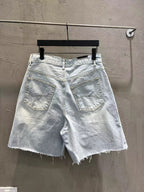 Light-wash denim shorts with stitched front pockets and frayed cuffs