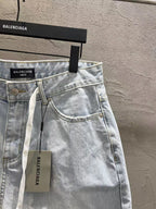 Light-wash denim shorts with curved pocket stitching and hanging drawstring tag