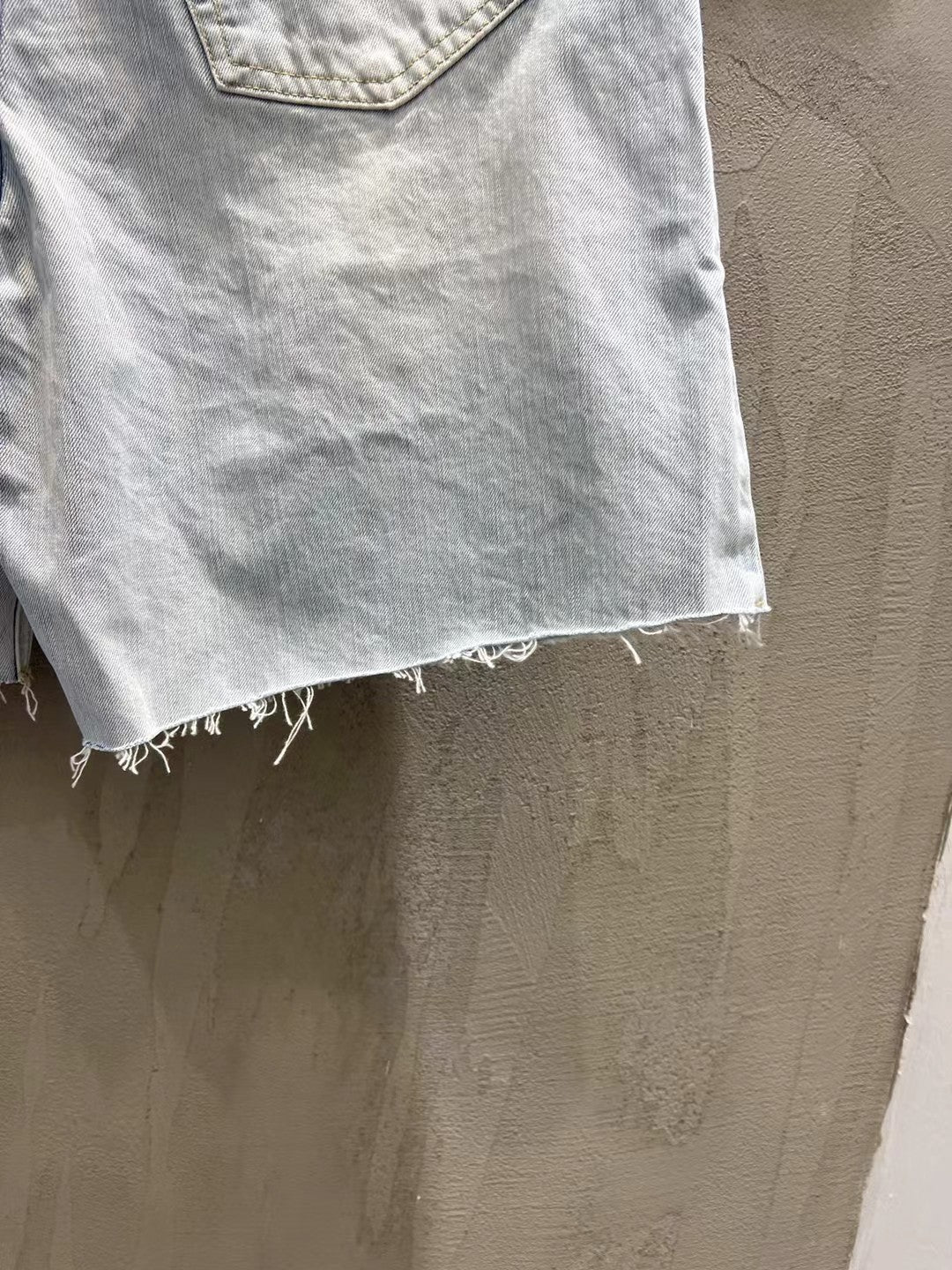 Light-wash denim shorts with frayed bottom hem