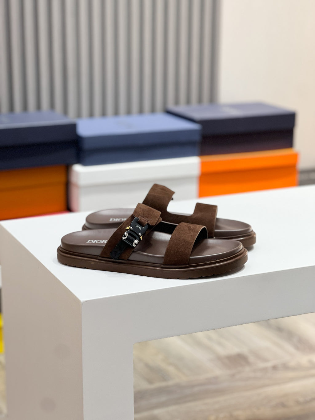 Brown Dior slide sandals with wide suede straps and adjustable buckle