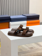 Brown Dior slide sandals with wide suede straps and adjustable buckle