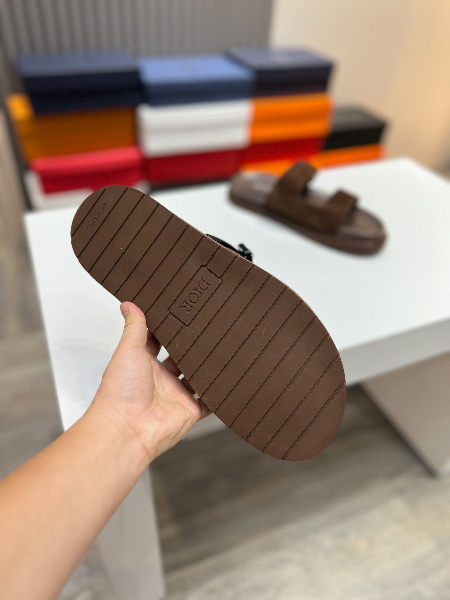 Brown slide sandal outsole with textured tread pattern