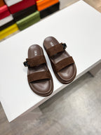 Brown Dior slide sandals with suede straps and metal buckle detail
