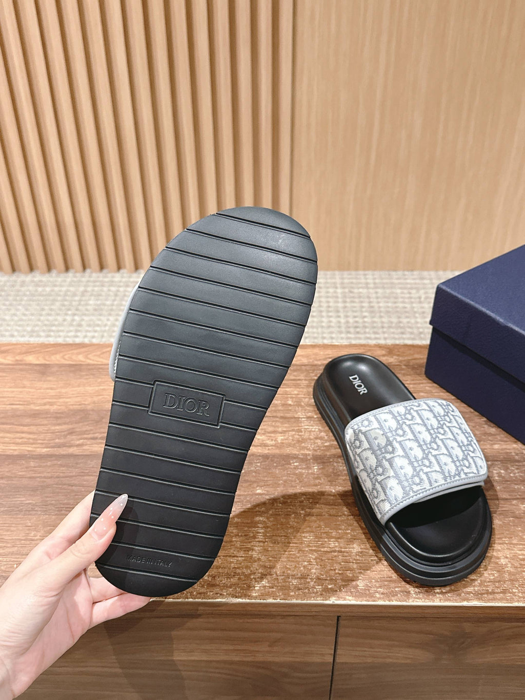 Dior slide sandal outsole with ridged tread and white logo-print strap