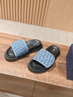 Dior slide sandals with blue patterned straps and black rubber soles