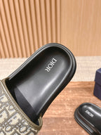 Black Dior slide sandal footbed with Dior logo and beige Oblique strap edge