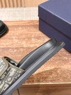 Black Dior slide sandal with beige Oblique strap and thick grooved sole