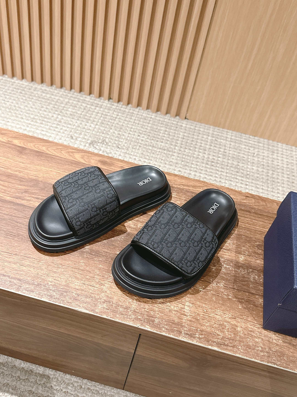 Dior slide sandals, dark logo-pattern upper, thick ridged black sole