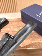 Dior slide sandals side view with black strap detail and thick ridged sole