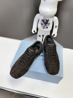 Prada unisex dark brown suede sneakers, side view on a box