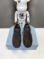 Pair of Prada unisex dark brown suede sneakers, lace-up front view