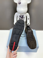 Prada unisex dark brown sneaker outsole with tread and red accent