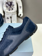 Navy suede low-top sneaker with side panel and dark rubber sole