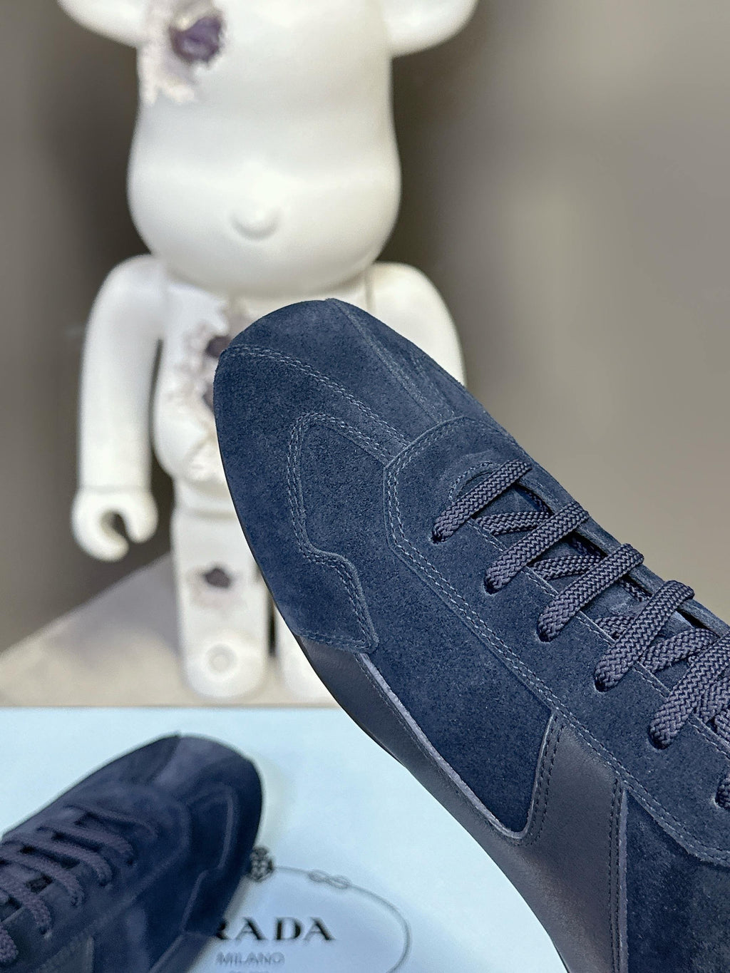 Navy suede lace-up sneaker with padded collar and seam detailing