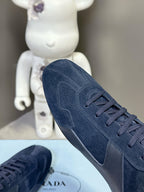 Navy suede lace-up sneaker with padded collar and seam detailing