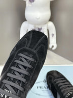 Unisex black lace-up sneakers with cross-stitch detail and padded collar