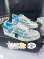 Blue and white low-top sneakers with rhinestone details, lace-up style