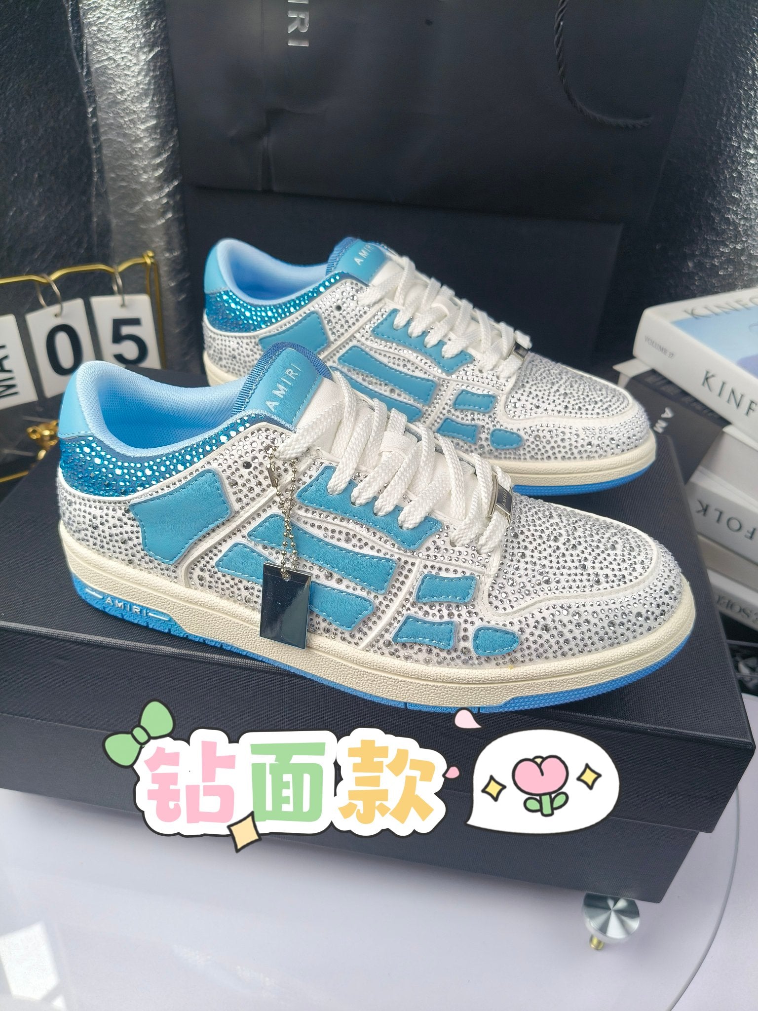 Blue and white low-top sneakers with rhinestone details, lace-up style