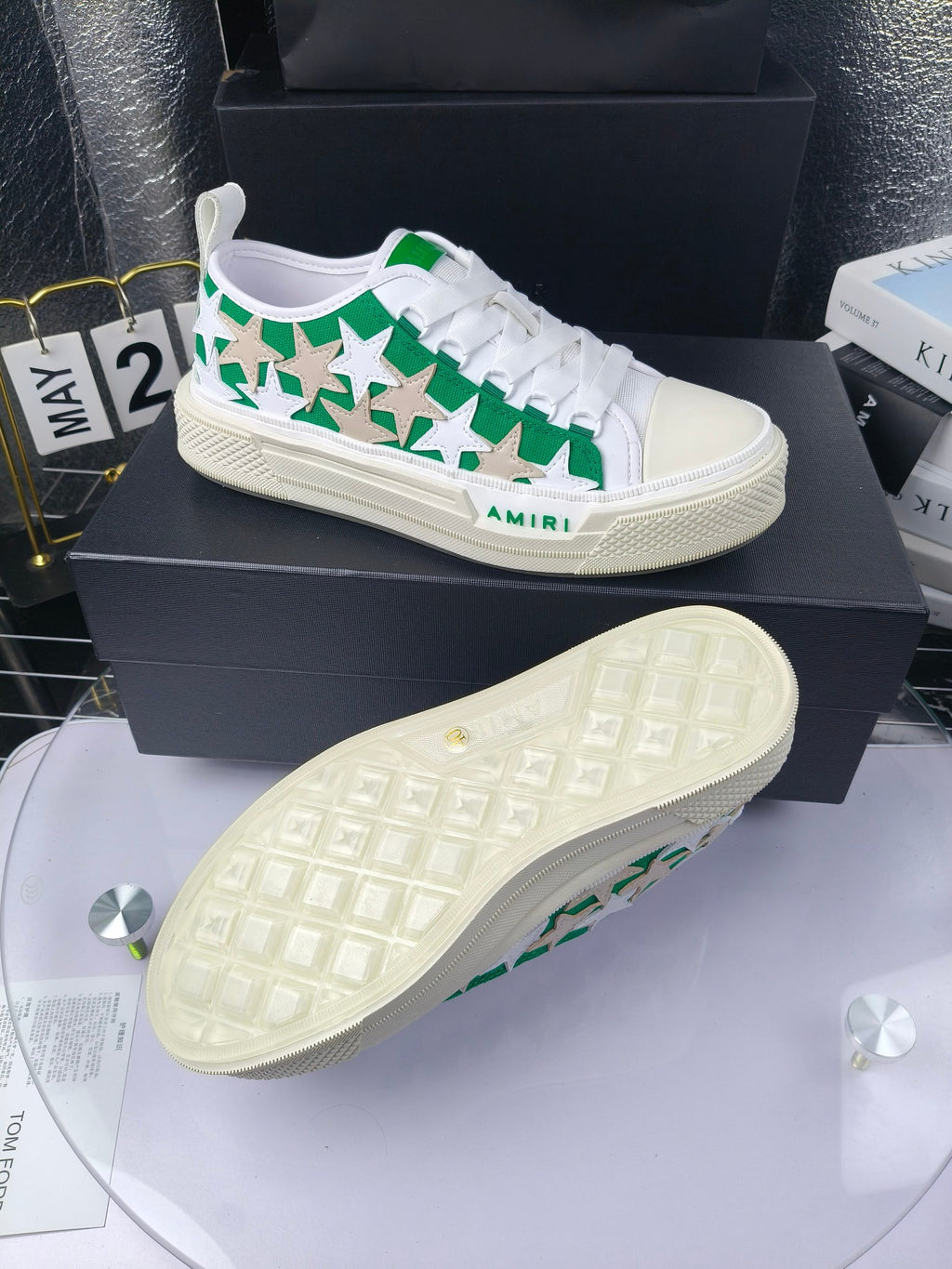 White sneakers with green star print; view of beige textured rubber outsole, Amiri