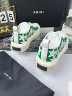 White sneakers with green star motif and dark heel tab detail, Amiri branding