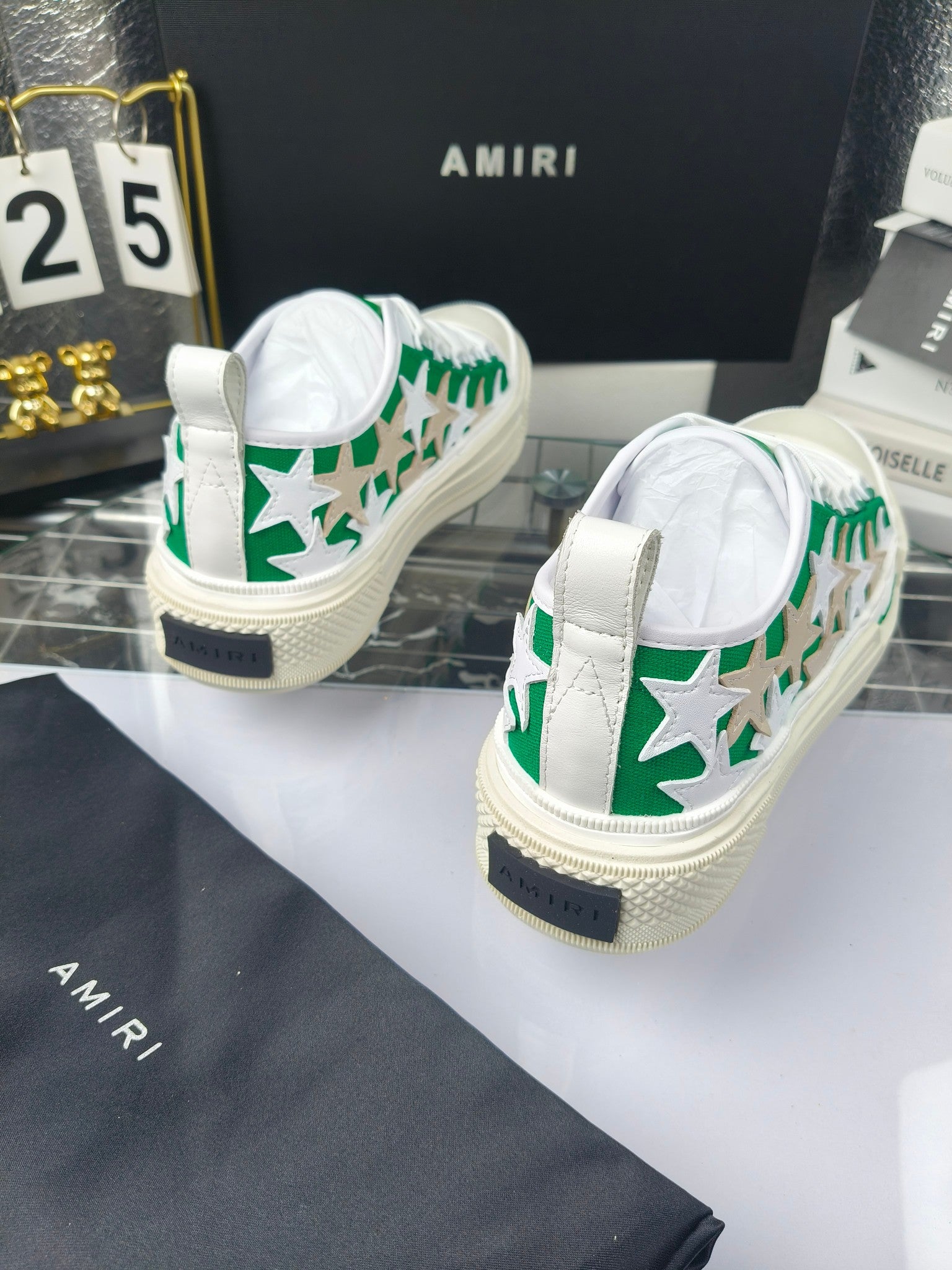 White sneakers with green star motif and dark heel tab detail, Amiri branding