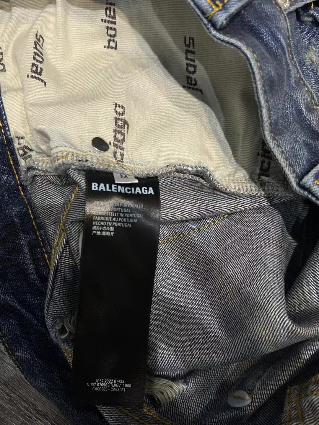 Interior waistband label and fabric lining of blue denim shorts