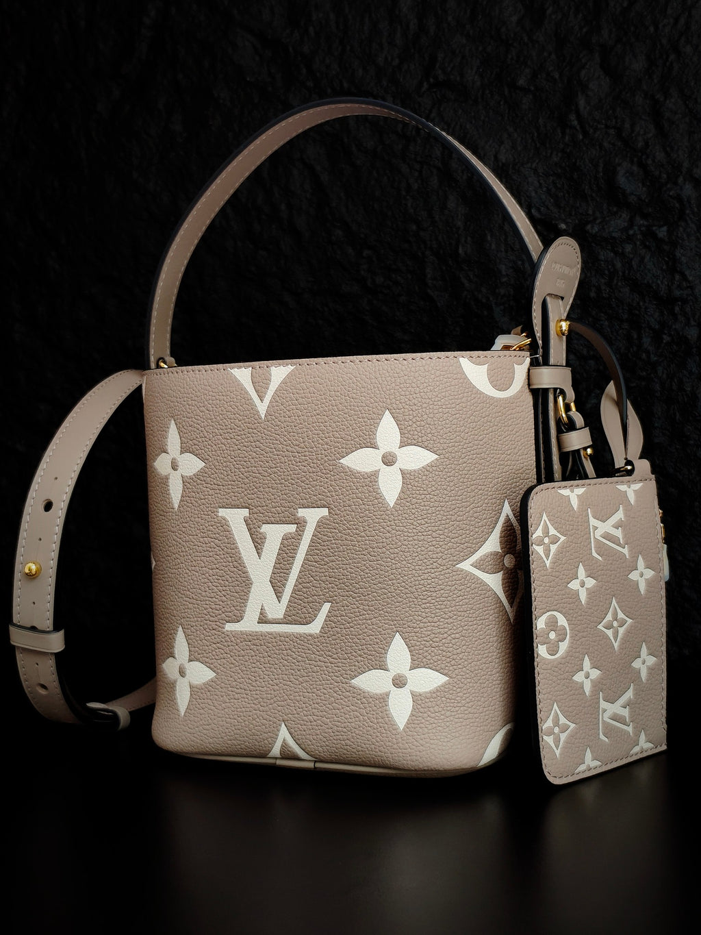 Louis Vuitton monogram bucket bag in light beige with white floral pattern and matching pouch