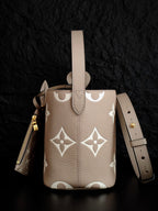 Louis Vuitton monogram bucket bag in light beige with white floral pattern, drawstring-style top