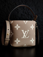 Louis Vuitton monogram bucket bag in light beige with white floral pattern and long shoulder strap