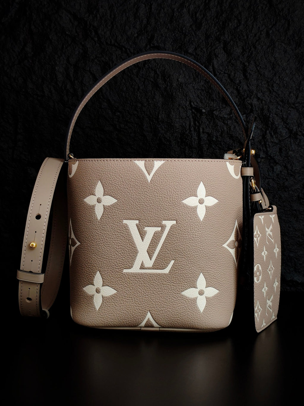 Louis Vuitton monogram bucket bag, light beige with repeating white floral logos, shoulder strap