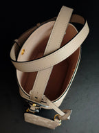 Louis Vuitton monogram bucket bag interior view, light beige exterior with long strap