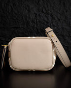 Louis Vuitton small crossbody bag in light beige with rounded flap and adjustable strap