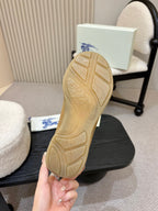Tan rubber outsole of suede sneakers with tread pattern