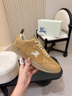Tan suede lace-up sneakers with white horse logo and cushioned tongue