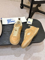 Tan suede sneakers with white horse logo patch and lace-up front, low sole