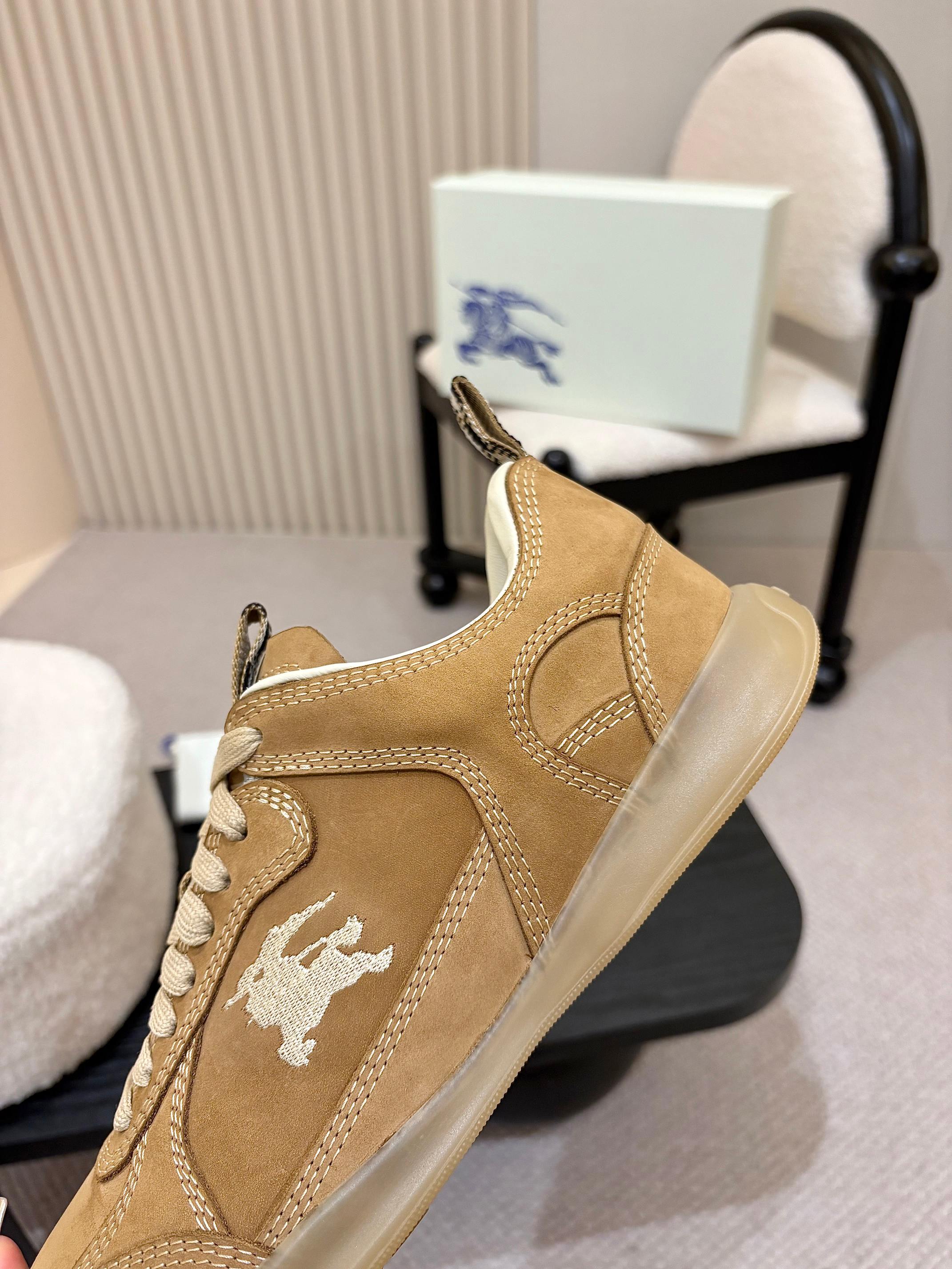 Tan suede sneakers with white horse logo and contrasting light sole, side view