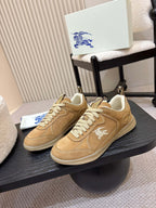 Pair of tan suede sneakers with white laces and white horse logo on side panels