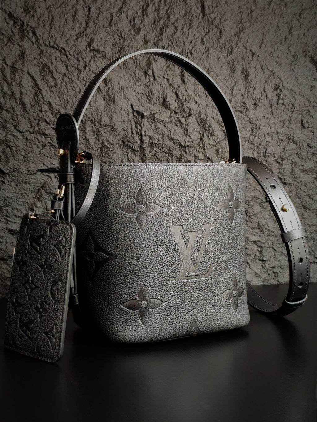 Louis Vuitton monogram bucket bag in gray with long shoulder strap and key pouch