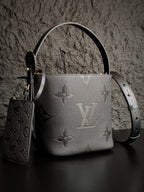 Louis Vuitton monogram bucket bag in gray with long shoulder strap and key pouch