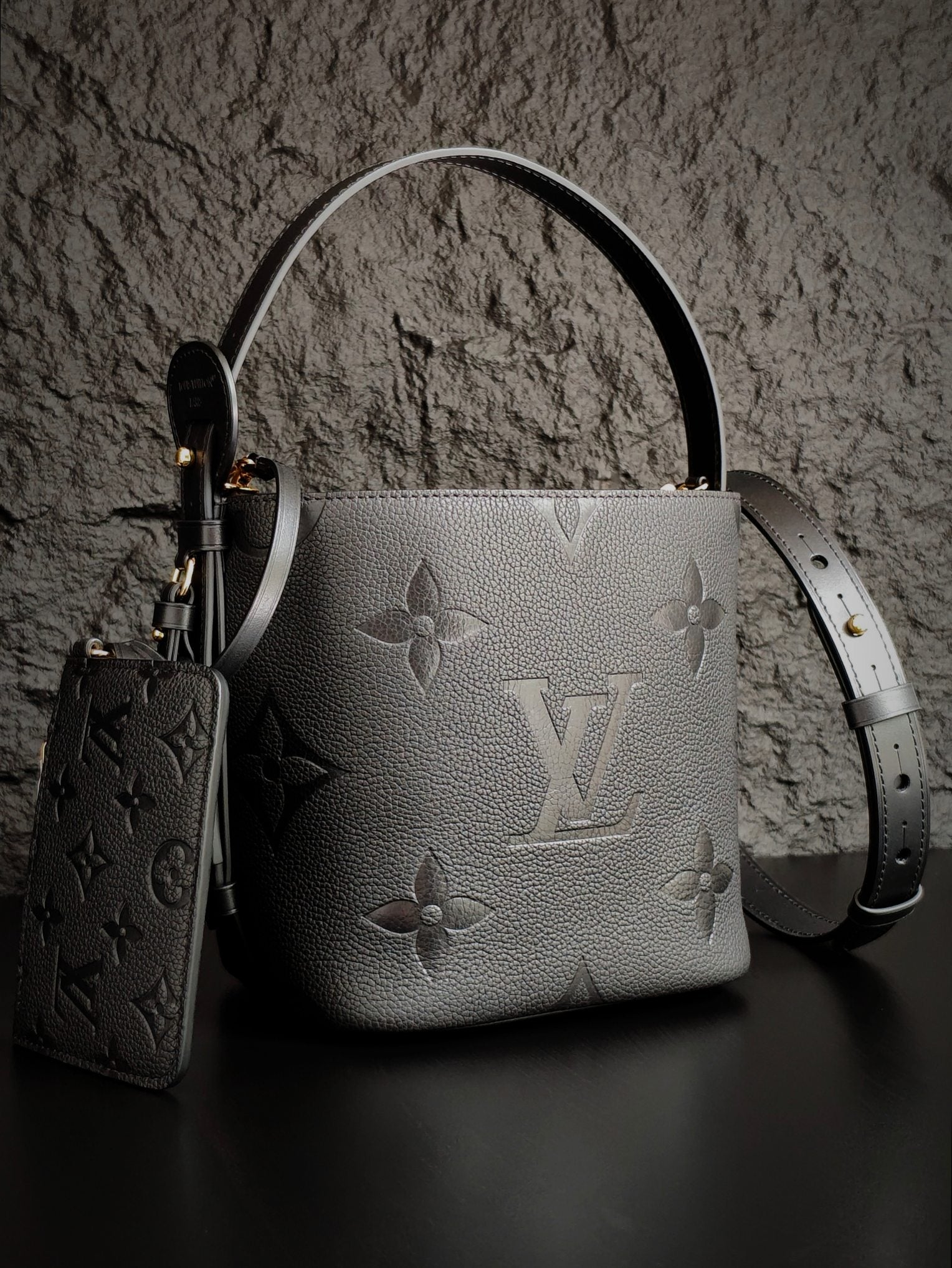 Louis Vuitton monogram bucket bag in gray with long shoulder strap and key pouch