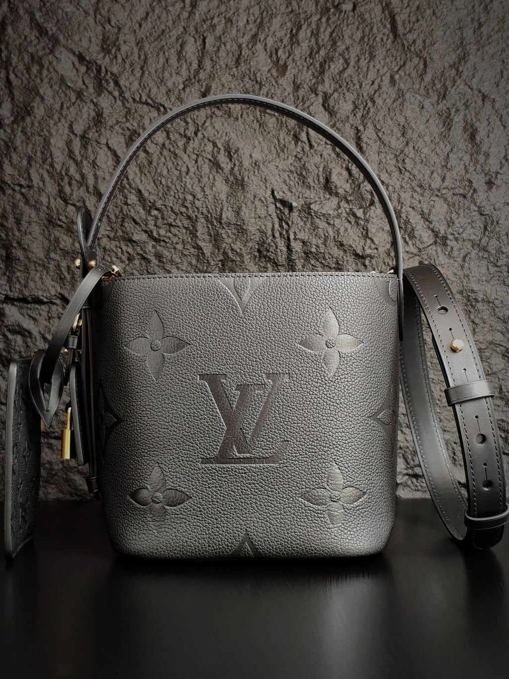 Louis Vuitton monogram bucket bag in gray with top handle and detachable strap