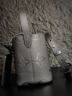 Louis Vuitton monogram bucket bag in gray with vertical seams and leather straps