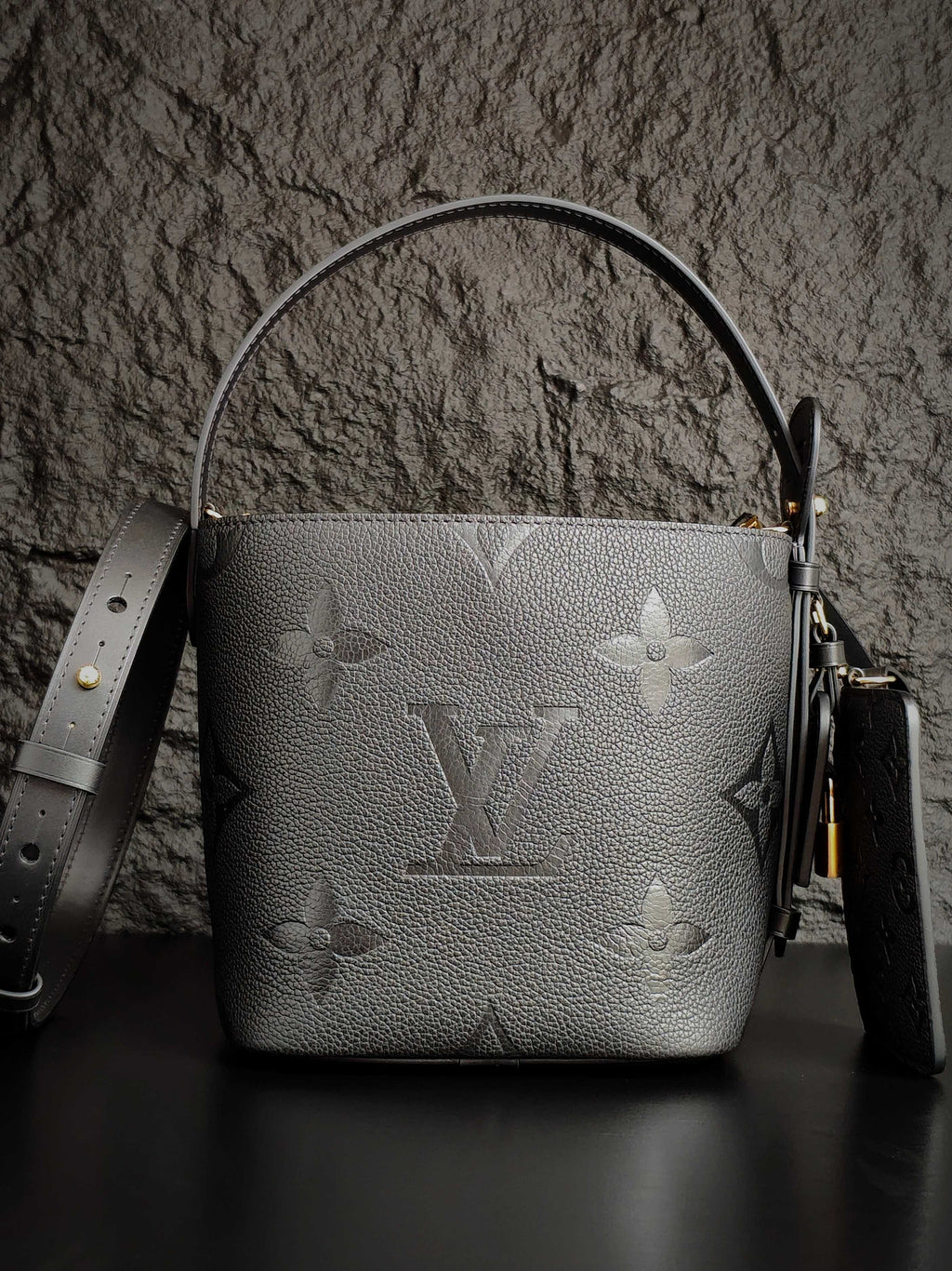Louis Vuitton monogram bucket bag in gray with side strap and gold hardware